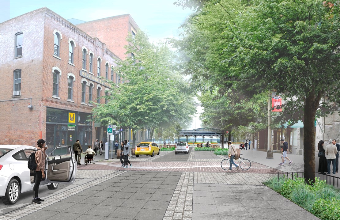 Rendering of the proposed improvements to Washington Street between First Avenue and Alaskan Way. There are no curbs and there are more planters and greenery lining the area. There are people walking, driving, talking, and biking along the street.  
